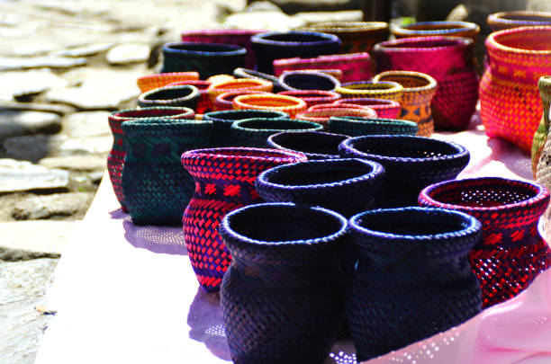 On the ground colored straw cachepot made by artisans from Paraty in Rio de Janeiro