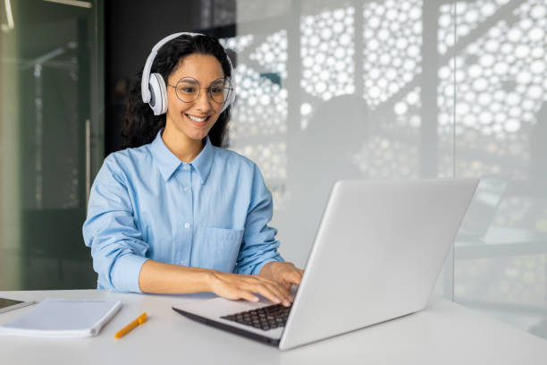 istock Young beautiful latin american programmer working inside office with laptop, woman coding new software security smiling and happy with achievement results 1599879225