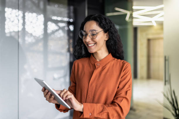 istock Indian female programmer standing inside the office with a tablet computer in her hands, the woman is testing a new software application 1599879662