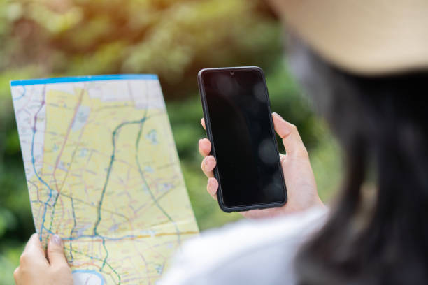 istock Cropped unrecognizable woman traveler using smartphone browsing on map app standing on slope of amazing landscape 1599879943