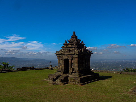 Ijo Temple (Candi Ijo) is a Shiva Hindu temple that is estimated to have been built in the 9-10th century on a hill known as Bukit Hijau which is about 410 m above sea level. Ijo Temple was built during the Ancient Mataram Kingdom under the reign of Rakai Pikatan and Rakai Kayuwangi. The Ijo Temple complex consists of 1 Main Temple and 3 ancillary temples which are decorated with various reliefs of plant vines and dwarf giants. The temple complex consists of 17 structures divided into 11 terraced terraces. Ijo Temple was built as a place for worshiping the gods for Hindus. The construction of Ijo Temple which is located on a hill aims to get closer to Kahyangan