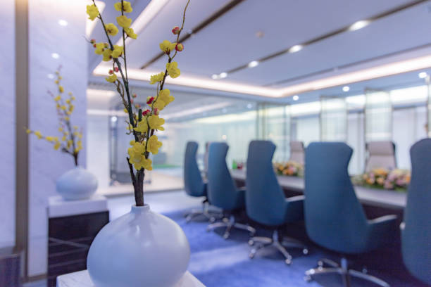 Yellow vases are placed in a modern meeting room
