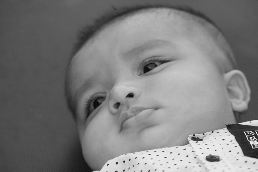 Close Up Shot of Cute Asian Pakistani 4 Months Old Baby Boy, Who is Enjoying at Home Garden at Luton City of England UK. Image Was Captured on July 23rd, 2023