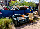 Dumpster full of garbages at residential garbage dump area