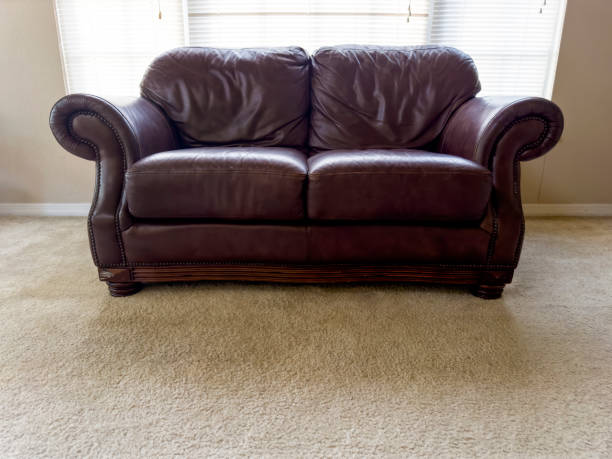 istock Single leather sofa by window of living room 1600121954