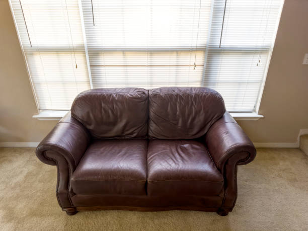 istock Single leather sofa by window of living room 1600122027