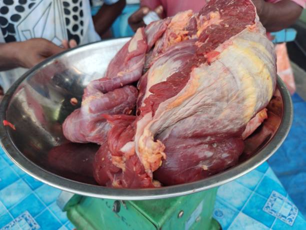 Beef cut in the belly and placed on the scales for sale.