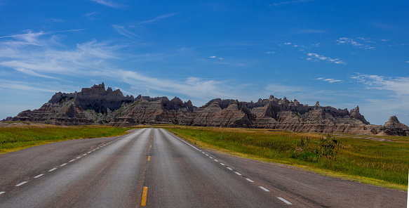 Road heading into the Badlands of South Dakota on a beautiful day