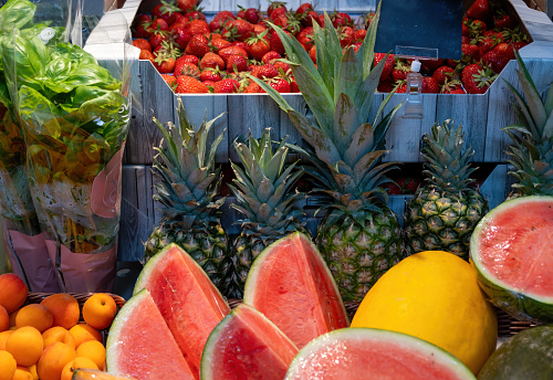 Fruit stand with strawberries, pineapples, and more
