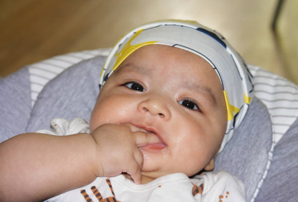 Close Up Shot of Cute Asian Pakistani 4 Months Old Baby Boy, Who is Enjoying at Home Garden at Luton City of England UK. Image Was Captured on July 23rd, 2023