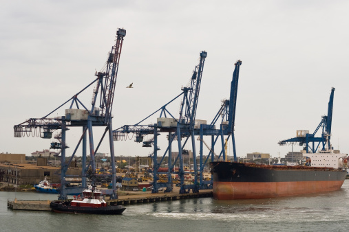 An hazardous cargo ship at the dock along with a tugboat in Galveston, Texas.