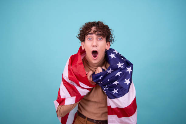 istock Young attractive guy with usa flag. 1600205152