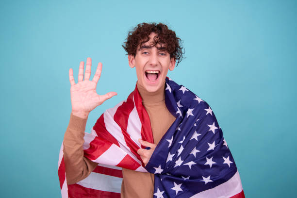 istock Young attractive guy with usa flag. 1600205675