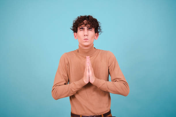 istock Emotional guy is surprised, happy and sad posing in the studio on a blue background. 1600209004