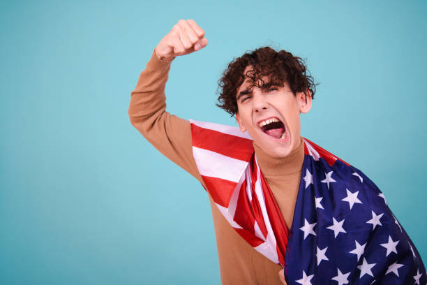 istock Young attractive guy with usa flag. 1600216339