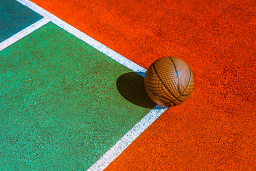 Basketball ball on the ground at sports field
