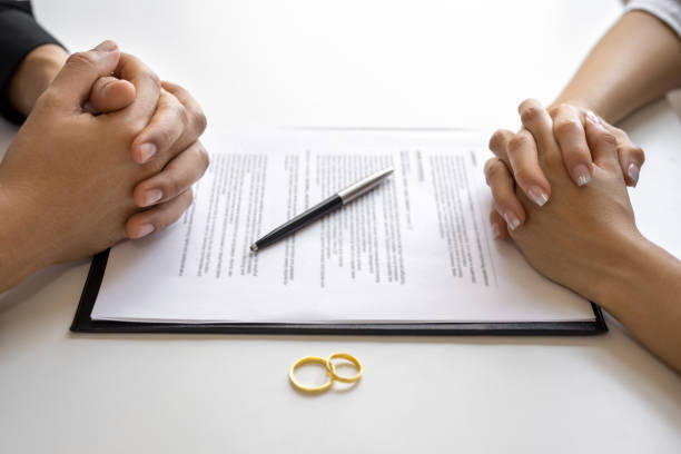 istock Divorce agreement and wedding rings 1600277567
