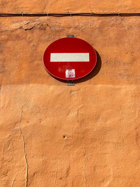 Low angle view of Do Not Enter sign hanging from wall in the city of Valencia, Spain