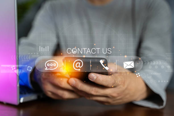 istock Contact us or Customer support hotline people connect. Businessman using a laptop and touching on virtual screen contact icons. 1600295691