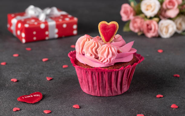 istock Cupcake Red velvet decorated heart cookie, and gift on gray background 1600310870