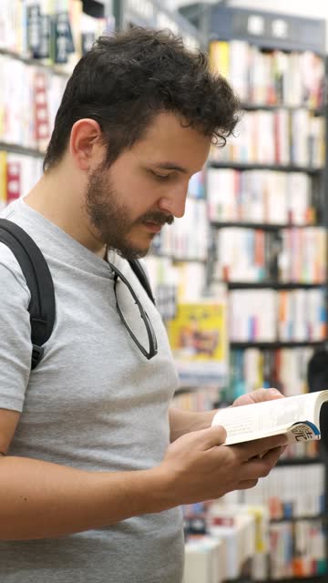 Latin tourist reading a comic at a Japanese comic book store in Tokyo.