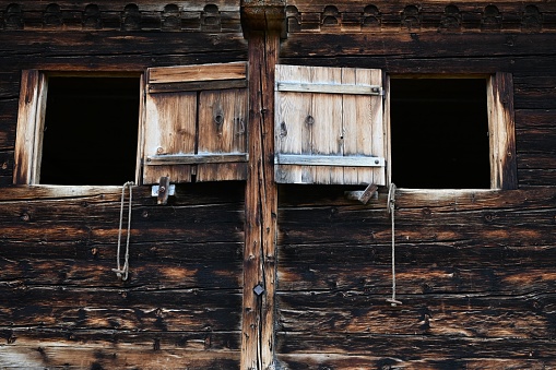 A low angle of an old wooden barn with tiny windows