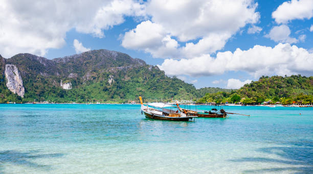 istock Longtail boats on a clear water beach on Phi Phi Don island. 1600347870
