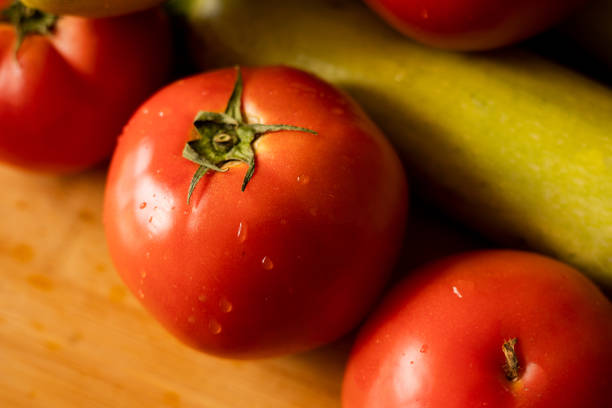 istock raw tomatoes and zucchini on wooden board 1600359940