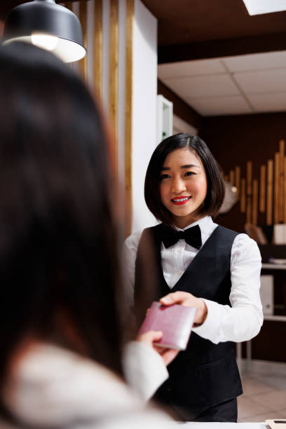 istock Hotel receptionist receives passport 1600367992