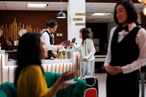 istock Receptionist checking tourist passport 1600387792