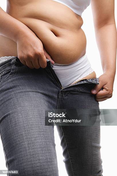 Overweight Woman Trying To Wear Tight Jeans Stock Photo - Download Image Now - Jeans, Pulling, Women