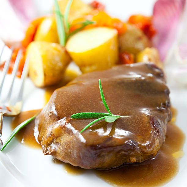 Roast pork with sauce and rosemary