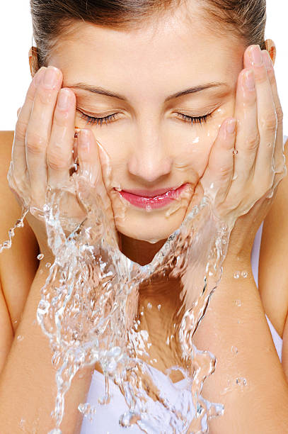 istock Cute woman wash her  face with water 160042417