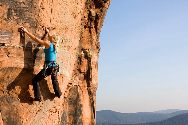 istock Hey young woman climbing a wall  160043200