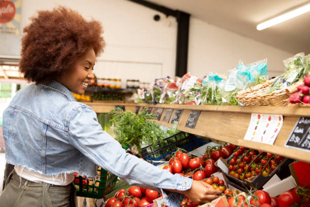 istock Young woman shopping for tomatoes 1600436900