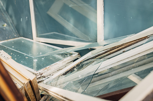 Old Windows in dumpster ready to recycle