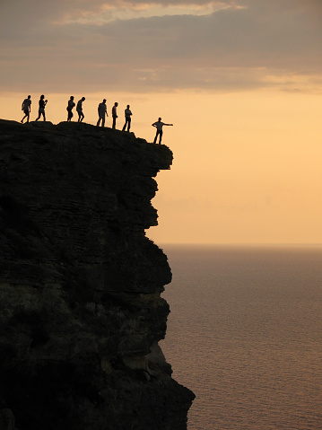 people standing on mountain top