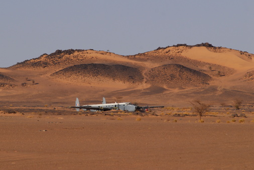 Plane wreck of a vintage SAAF Avro Shackleton reconnaissance plane, in middle distance, that crash-landed in the Sahara desert, Western Sahara, Mauritania.