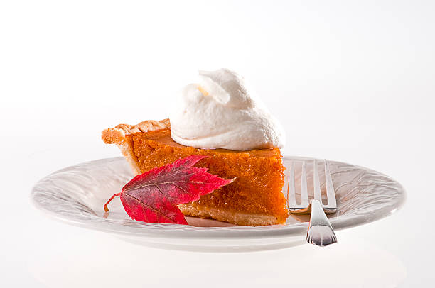Pumpkin pie and whipped cream stock photo