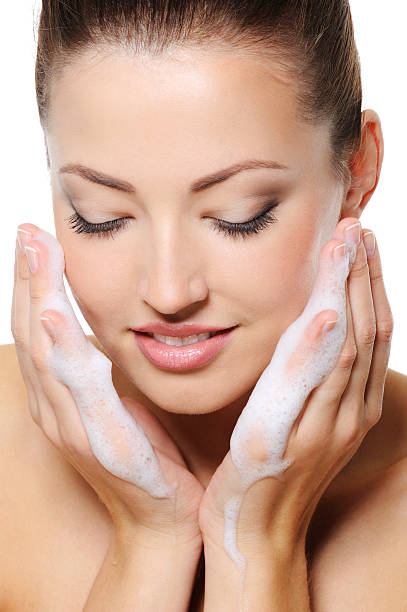 istock Woman with soap on her hands washing her face 160044636