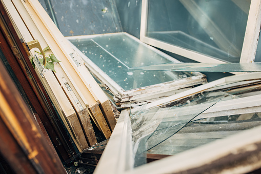 Old Windows in dumpster ready to recycle