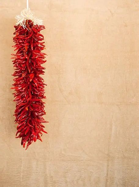 hanging red chile ristras with textured space for text or design elements