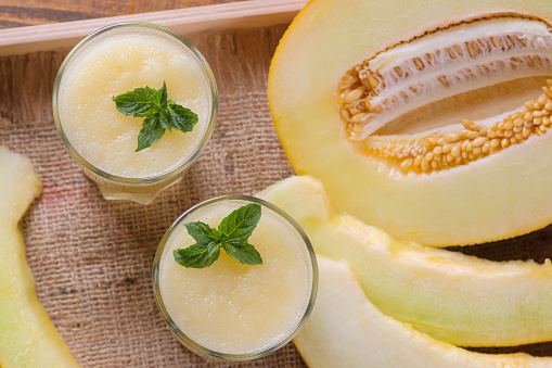 Delicious, healthy melon smoothie and fresh melon. top view
