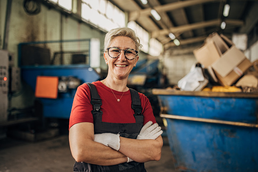 Portrait of proud female worker at recycling centre