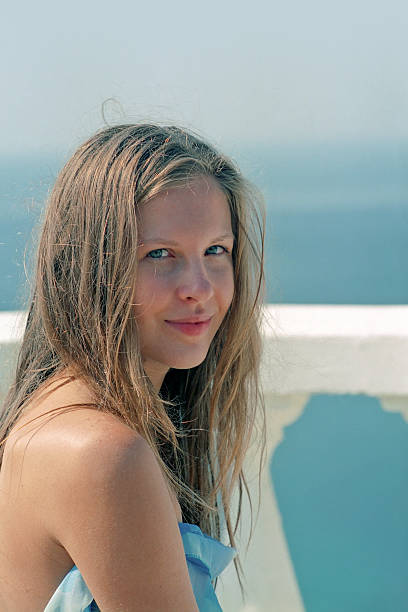 istock beautiful woman in blue relaxing on a beach 160045071