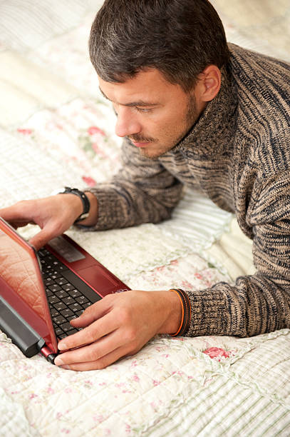 Young men working on laptop from his  house stock photo