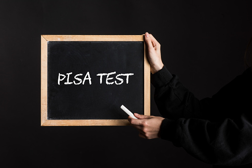 a blackboard sign with the word PISA Test written on it