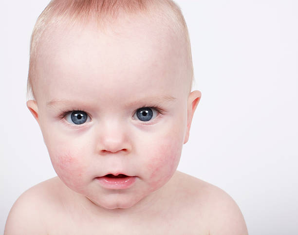 Small blue-eyed baby boy stock photo