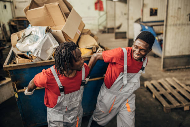 two-workers-in-recycling-centre-moving-big-dumpster-with-paper.jpg?s=612x612&w=0&k=20&c=28fSlO1BE2RgO2fzXPvJIwTbI4_d_IAPIDbJ_Gso_88=
