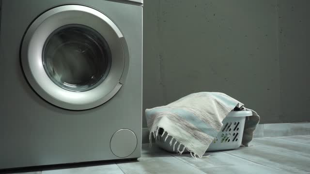 Washing machine with clothing inside a drum during cleaning and washing.Laundry room interior.
